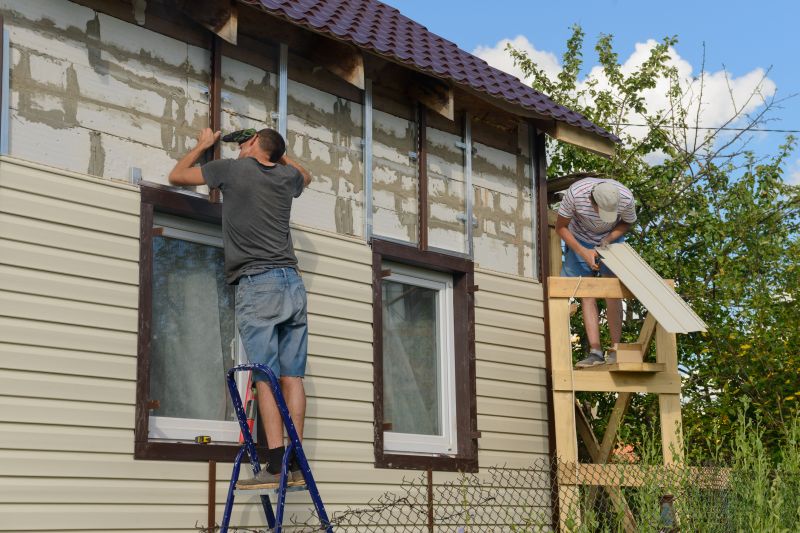 Professional Vinyl Siding Installer at Work